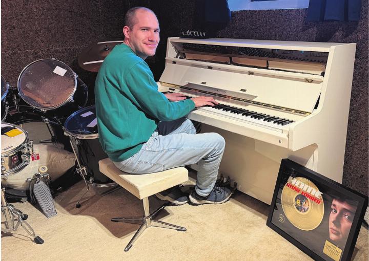 Tobias Gilgen mit der goldenen Auszeichnung im Kälberstall, wo er sein Tonstudio eingerichtet hat. Foto: Simone Rufli