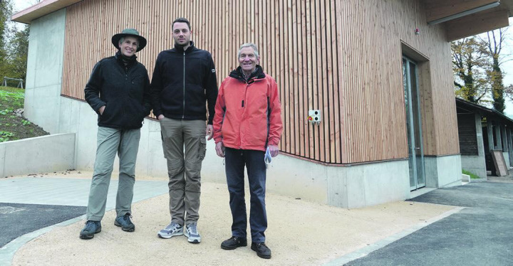 Holz aus dem heimischen Forst: Astrid Schwyter, Cyrill Wunderlin (Mitte) und Karl Bürgi vor dem neuen Gebäude, das die Holzschnitzel-Heizung beherbergt. Foto: Valentin Zumsteg